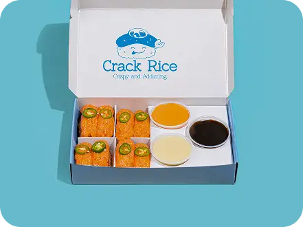 Spicy salmon sushi rice box with dipping sauces at Union Square's poke bowl spot.