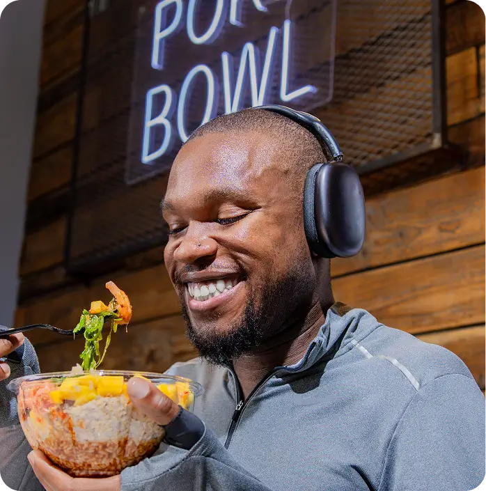 Man enjoying a poke bowl at Poke Bowl NY in Bryant Park.