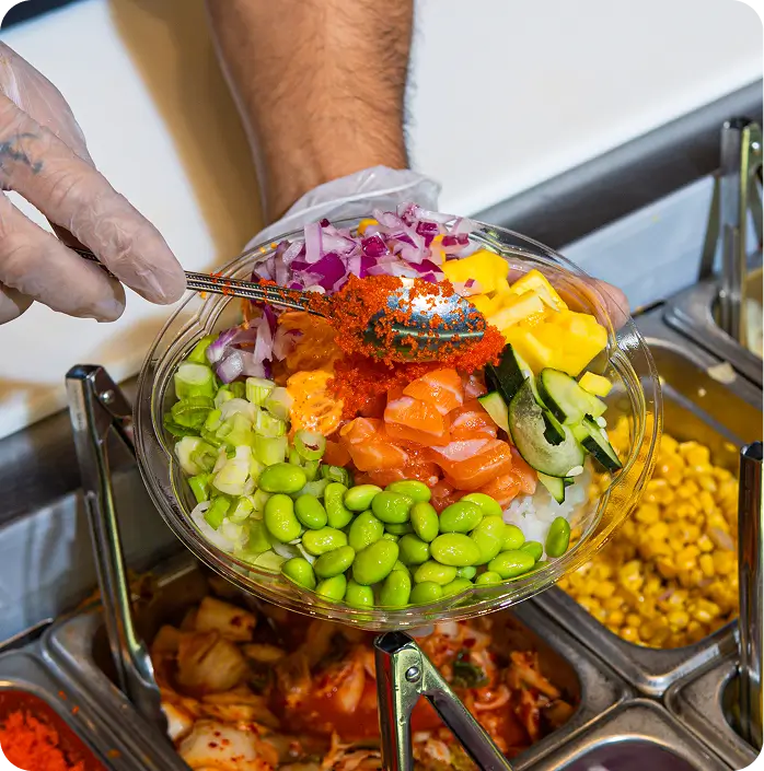 Hawaiian-style poke bowl with fresh ingredients being prepared at Chinatown Canal St shop.