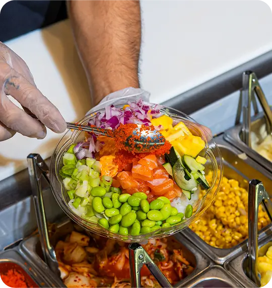 Hawaiian poke bowl with sushi-grade salmon, edamame, mango, onion, cucumber, served in Jersey City's Portland Center.