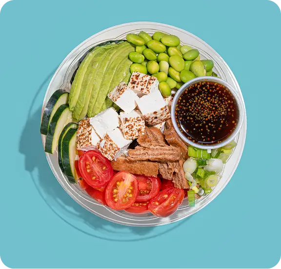 Vegan poke bowl with tofu, avocado, edamame, tomatoes, and soy sauce, featured by Poke Bowl in Hell's Kitchen.