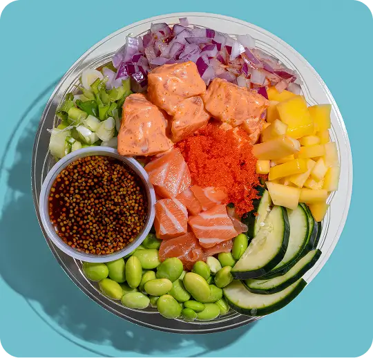Hawaiian poke bowl with fresh toppings like salmon, edamame, mango, and special sauce in Theatre District NY.