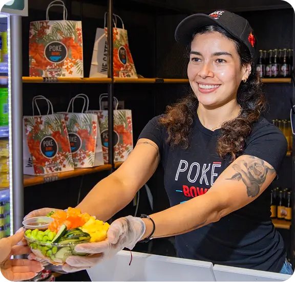 Fresh poke bowl served by smiling staff at Poke Bowl NY in Bryant Park.