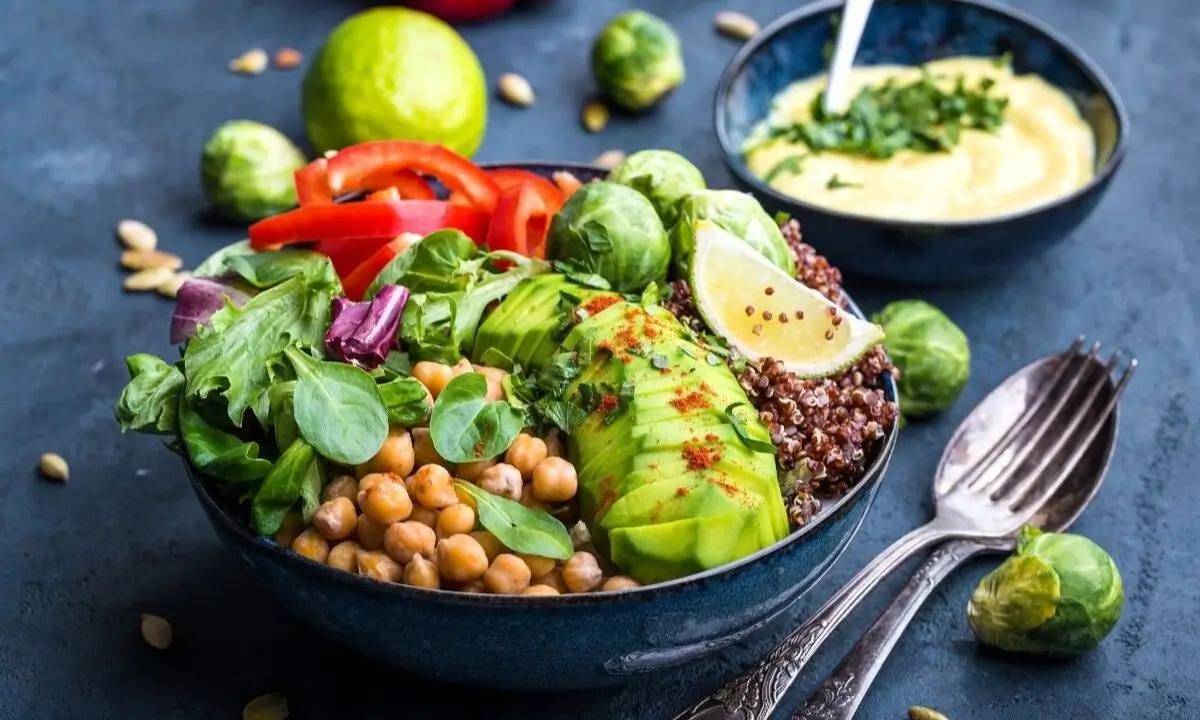 Vibrant poke bowl with avocado, chickpeas, mixed greens, and quinoa, ideal for NYC catering and dietary flexibility.