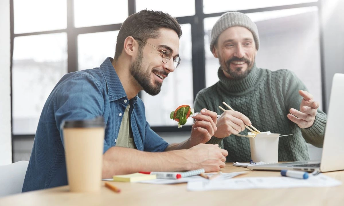 Office colleagues enjoying healthy poke bowls, enhancing lunchtime with a nutritious, customizable catering option.
