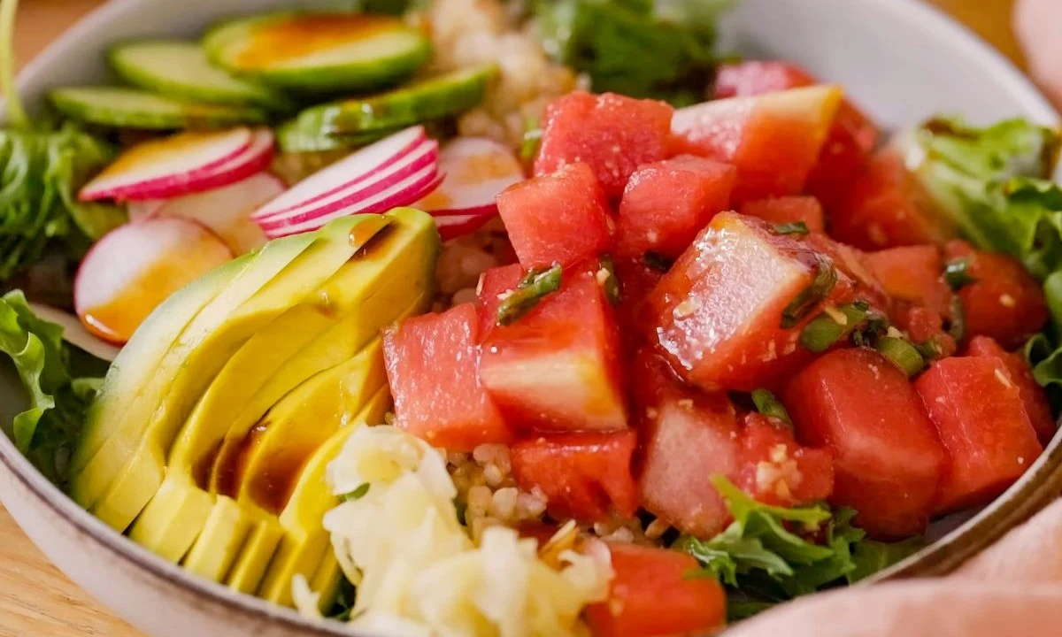 Vibrant vegan poke bowl with avocado, watermelon, radish, and cucumber, showcasing plant-based freshness and flavor.