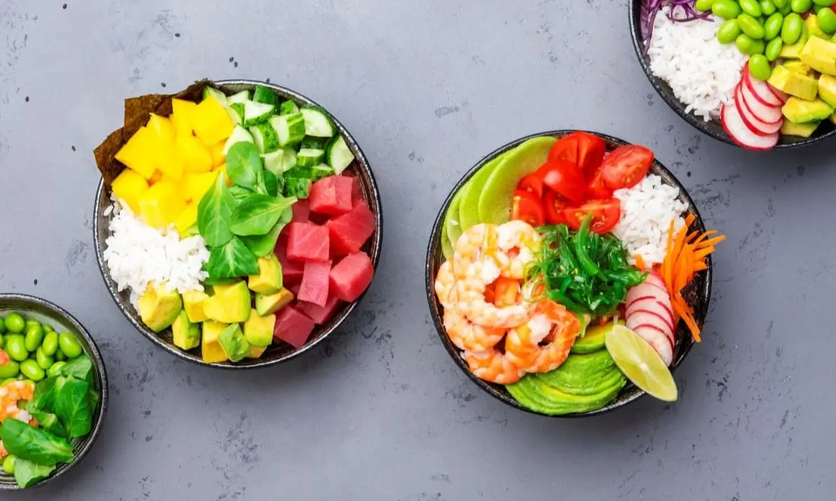 Colorful poke bowls with shrimp, tuna, rice, avocado, and veggies showcasing diverse cultural flavors.
